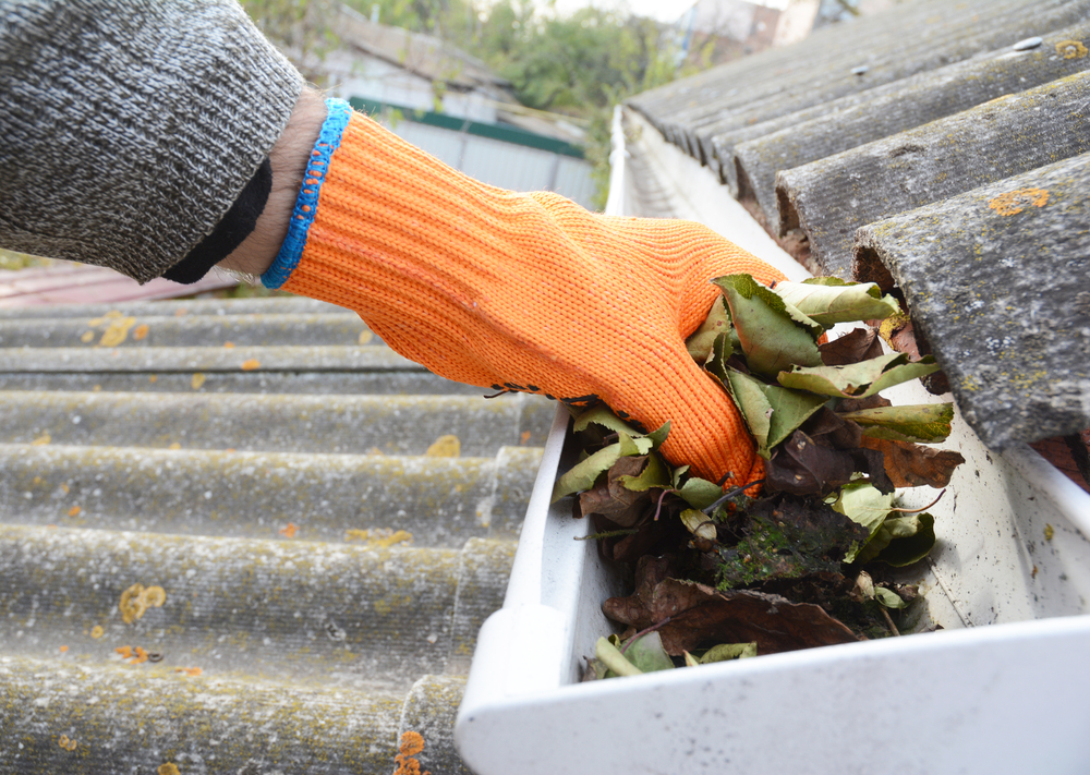 cleaning debris from gutter