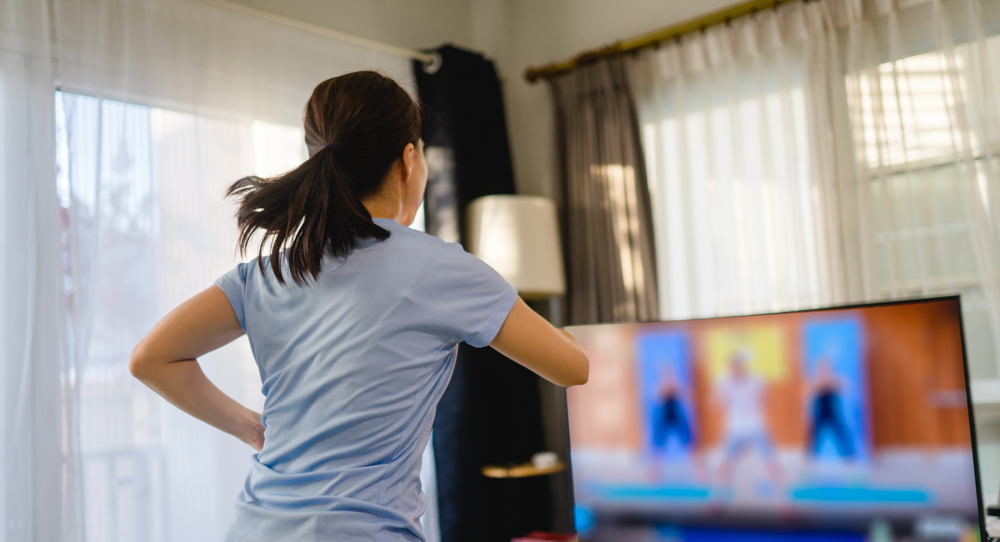 woman looking at tv while dancing