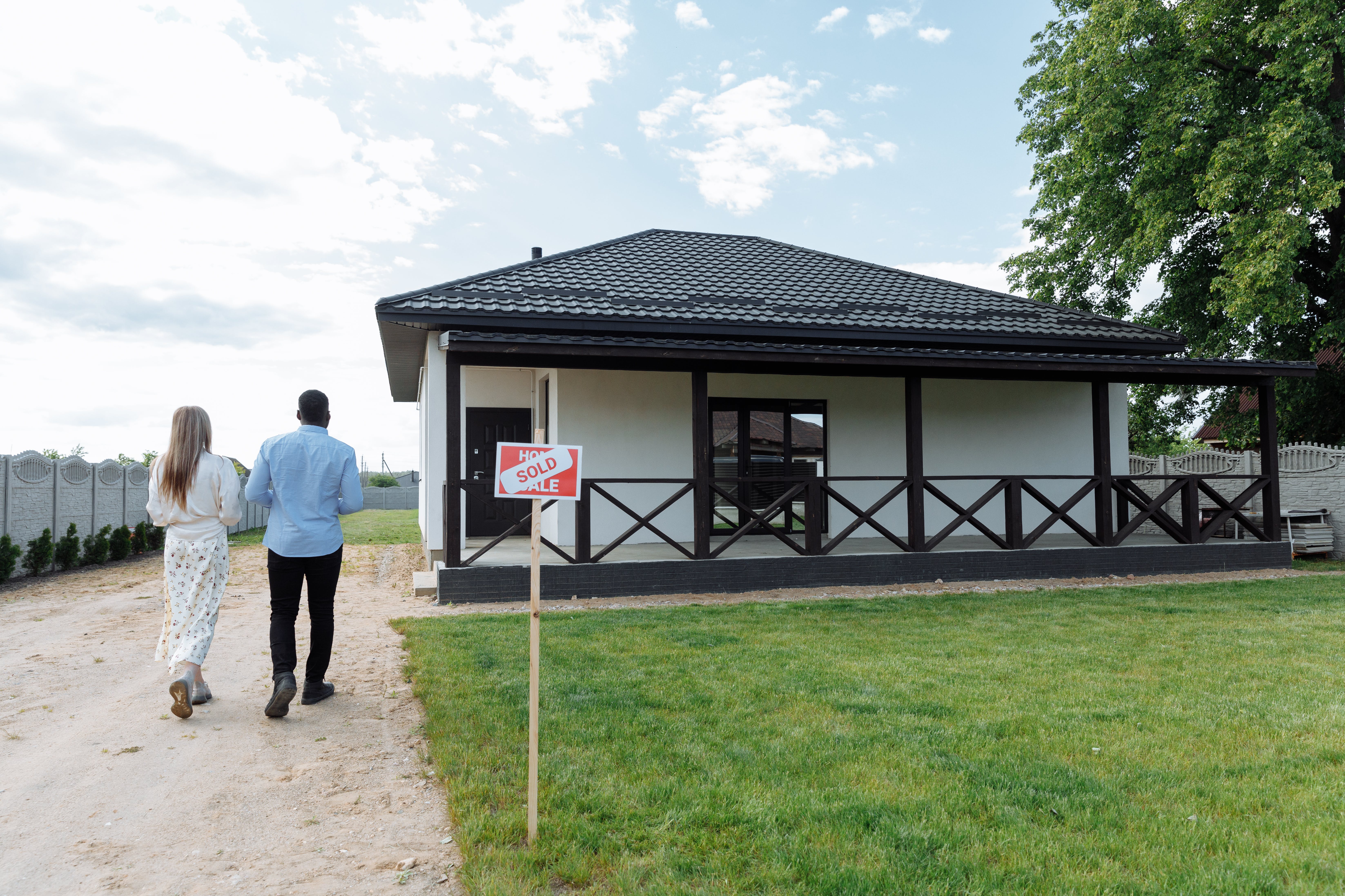 a couple walking towards a house