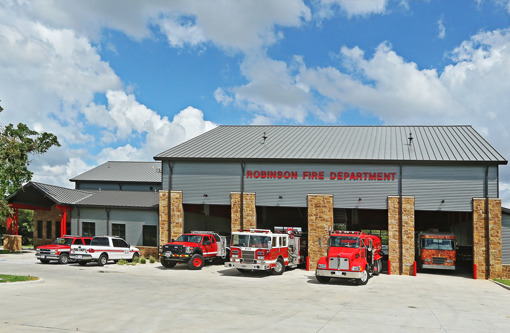 Front view of the robinson texas fire station with fire trucks in the open garages