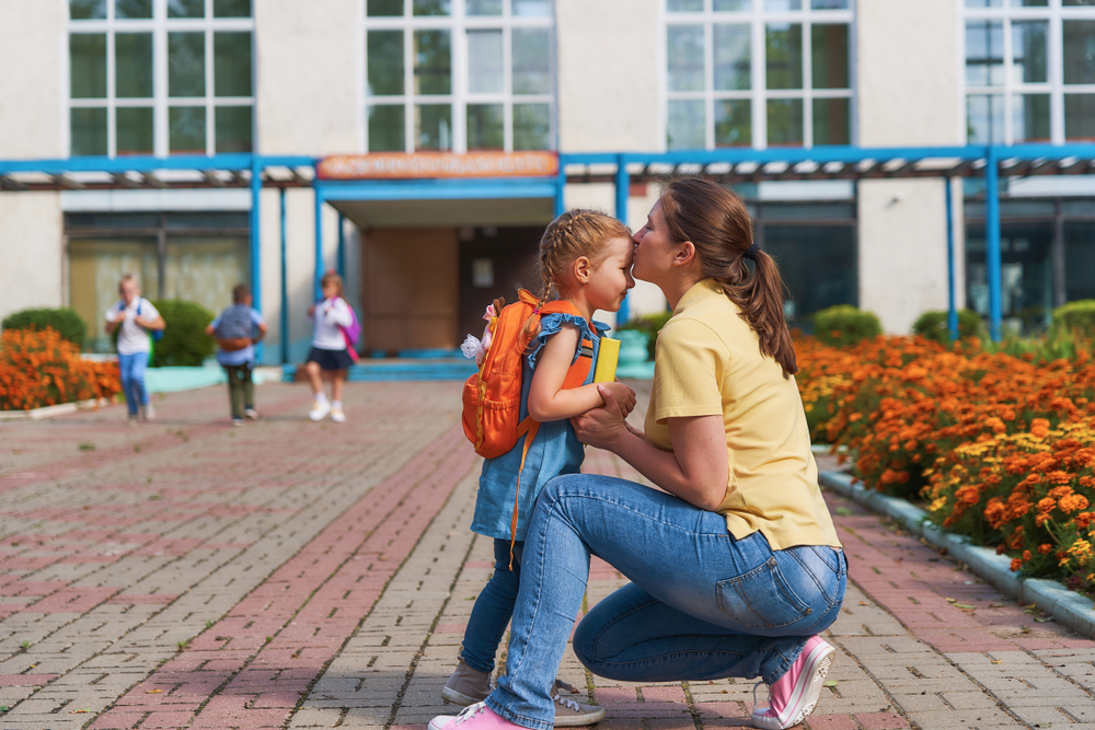 mother taking her daughter to school