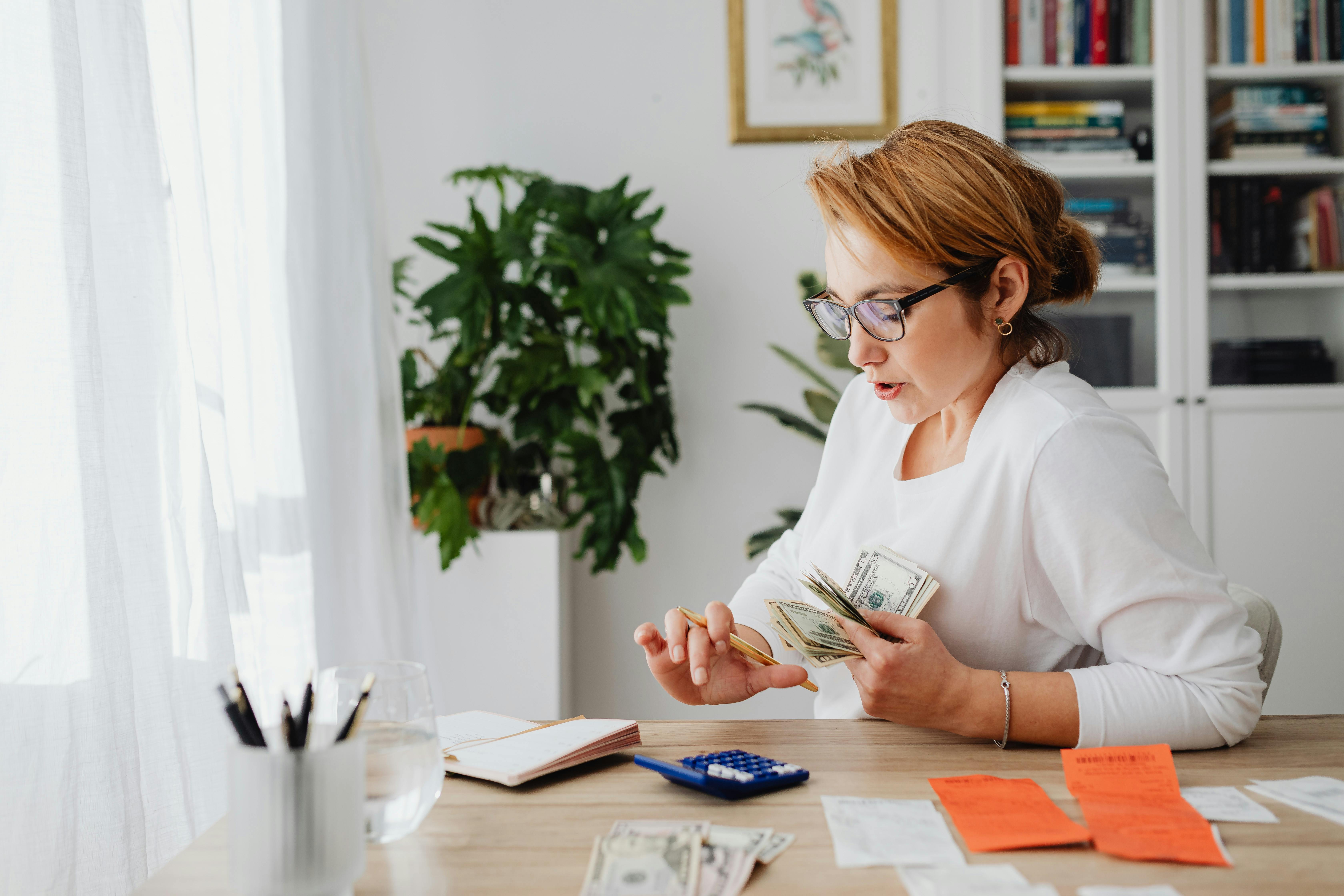 A woman counting and budgeting cash