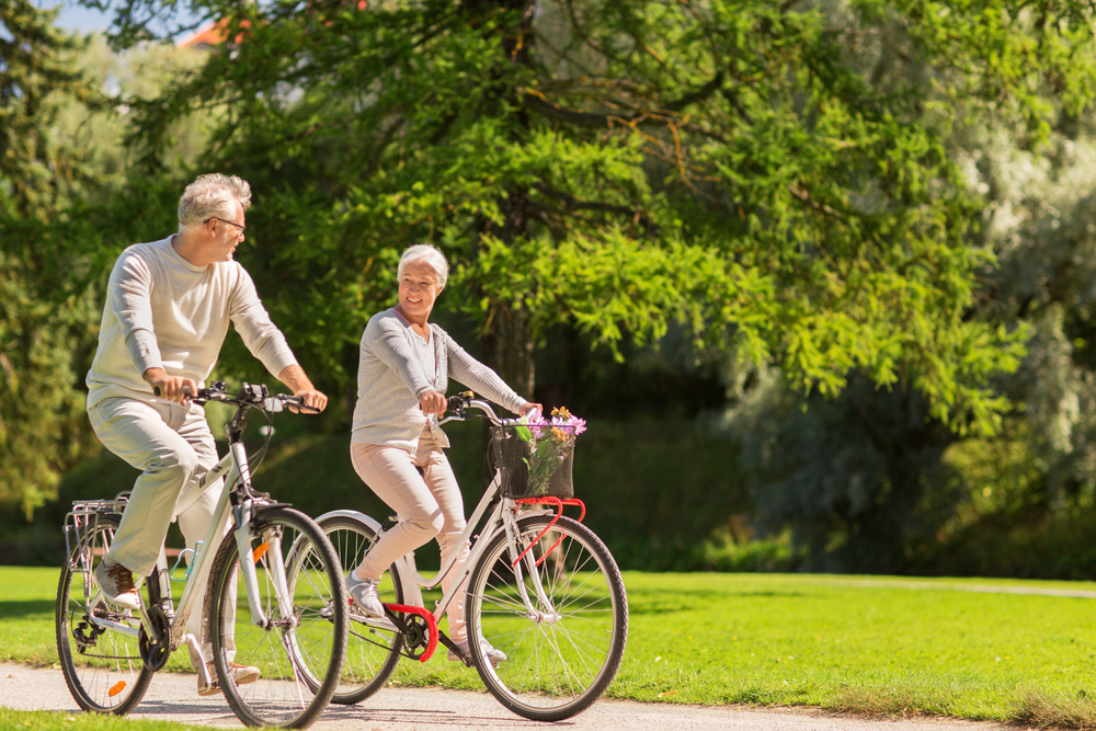 Senior-couple-riding-bicycles-at-the-park Senior couple riding bicycles at the park