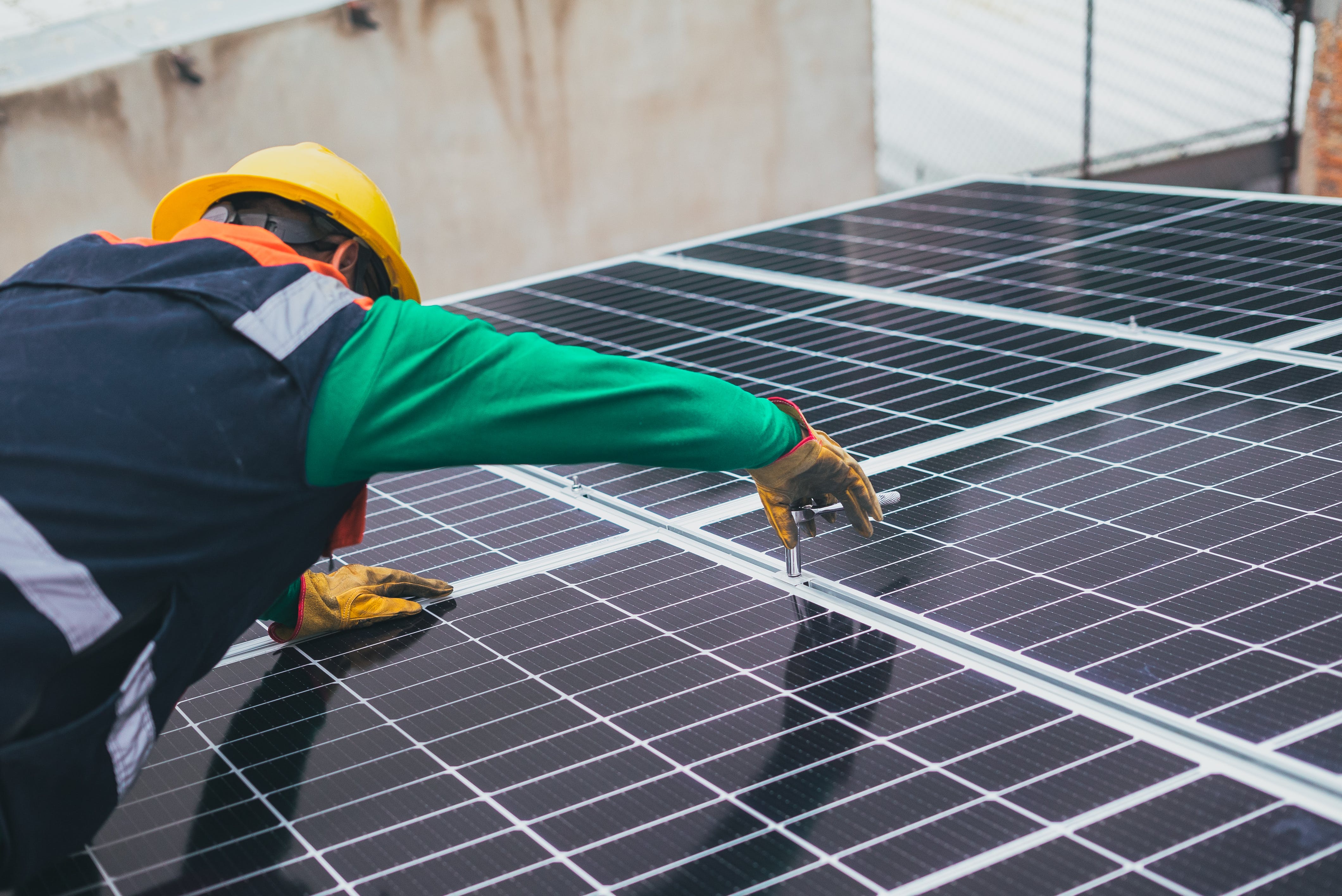 man-installing-solar-panels man installing solar panels