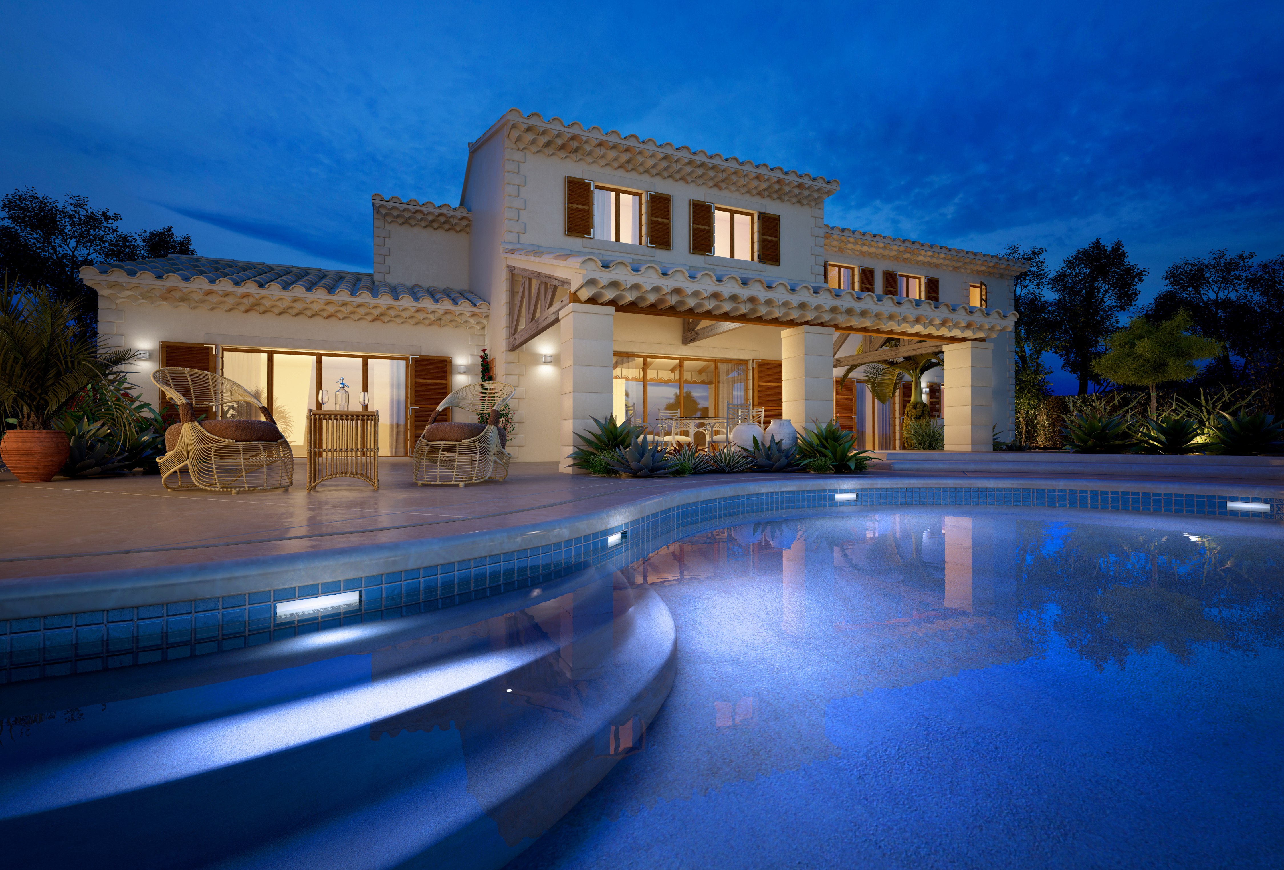 Luxurious villa with pool illuminated at night, perfect for relaxation and entertainment.