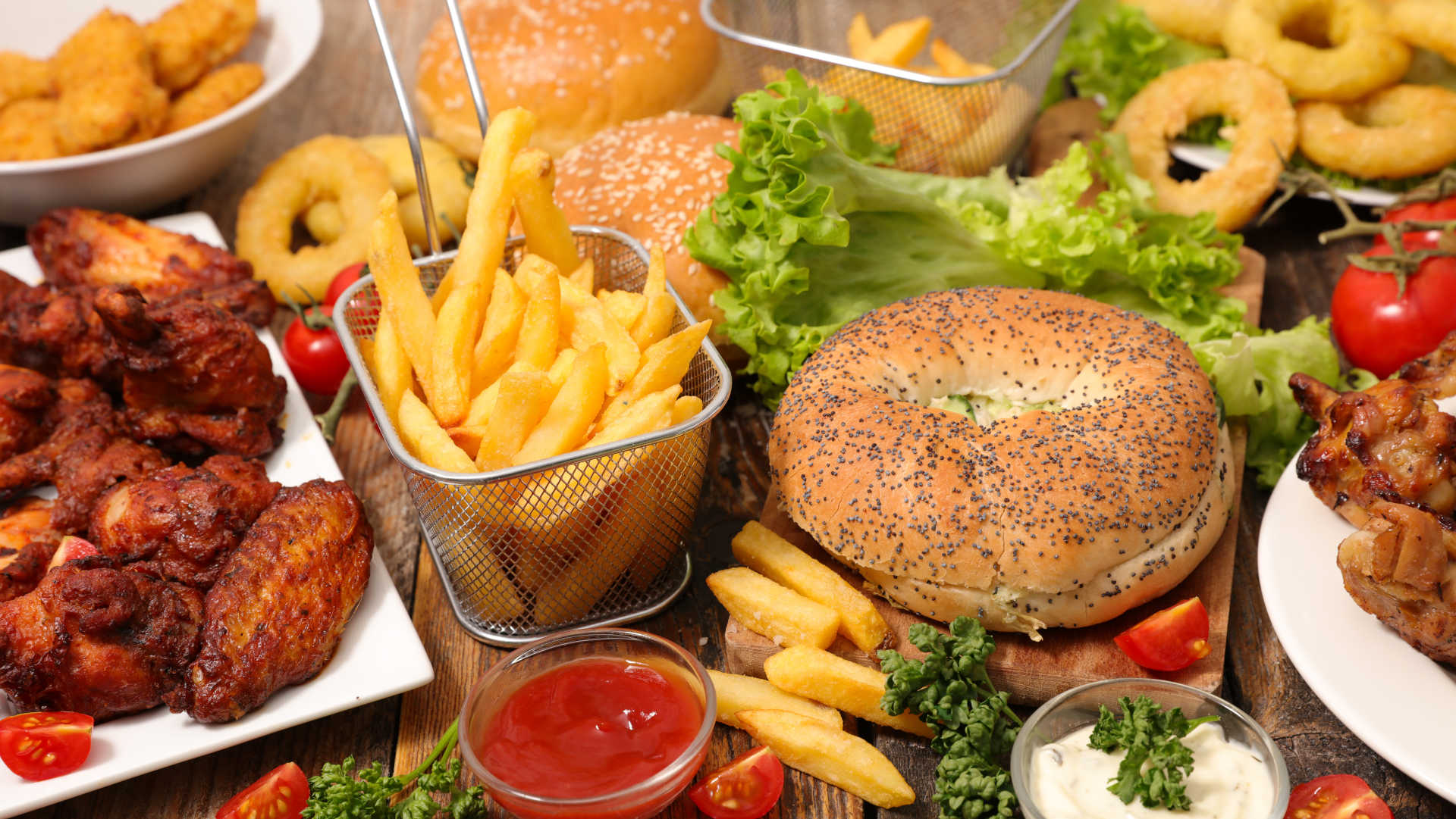 A colorful spread of delicious food featuring crispy french fries, juicy chicken, and mouthwatering hamburgers.