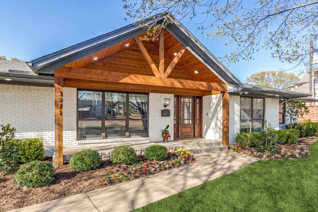 A spacious home featuring a large yard and an expansive driveway.