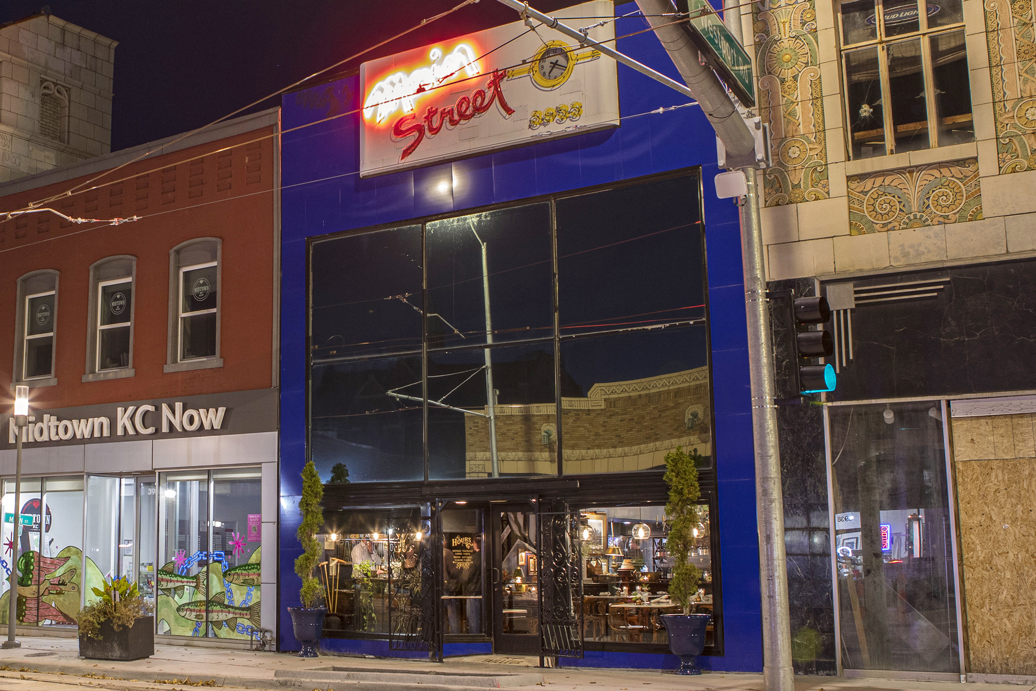 TAILLEUR is a distinctive, storied space featuring atmospheric high ceilings, open dining areas, and a kitchen surrounded by antiques and equestrian details. 