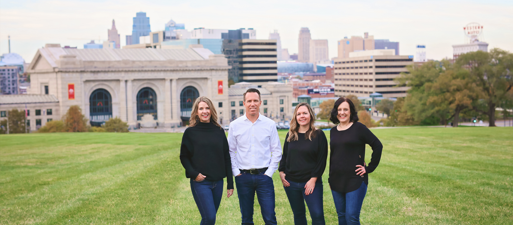 Lead Agent Miles Rost and The Rost Group team in front of the Kansas City skyline, serving buyers and sellers across the KC metro