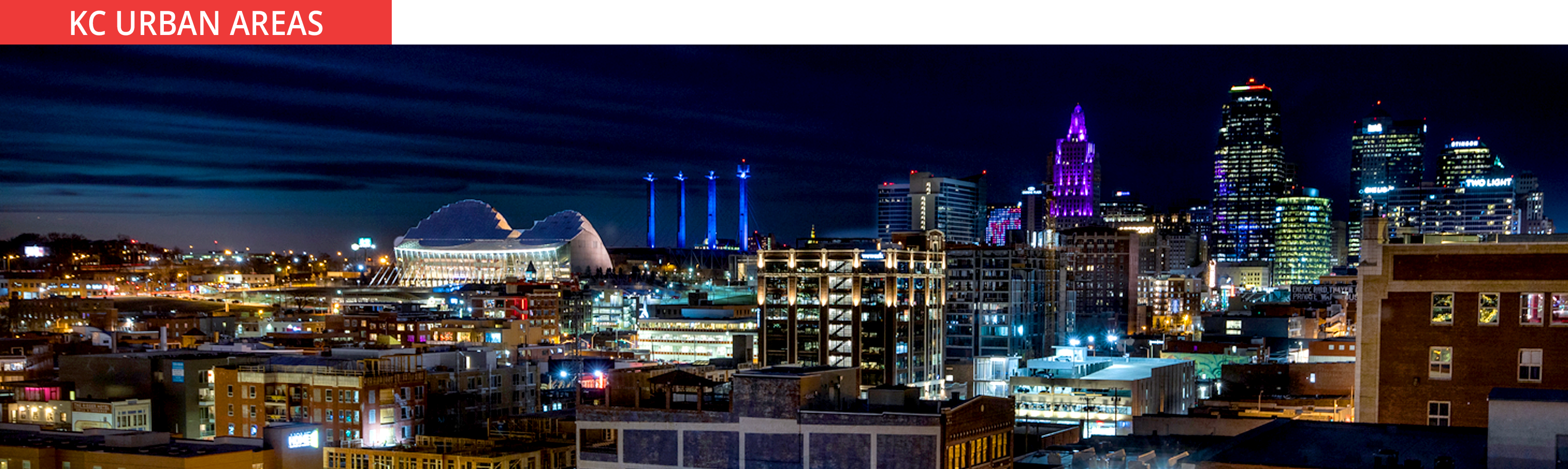 A view of the Kansas City skyline at night, representing urban homes and condo living in the KC metro area.