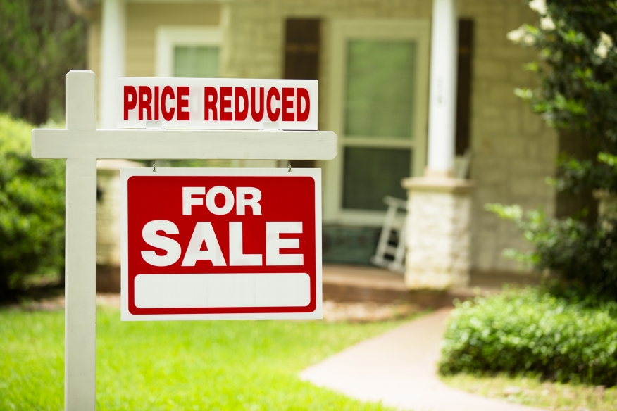 Price Reduced Sign Price reduced sign on a home for sale in Riverside, California