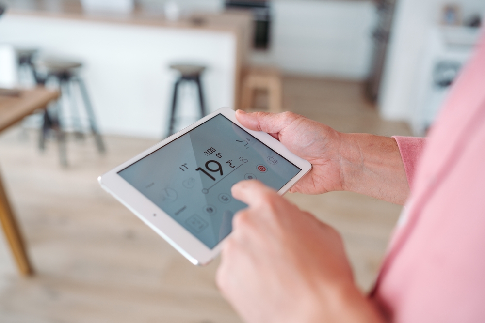 man holding smart home technology device