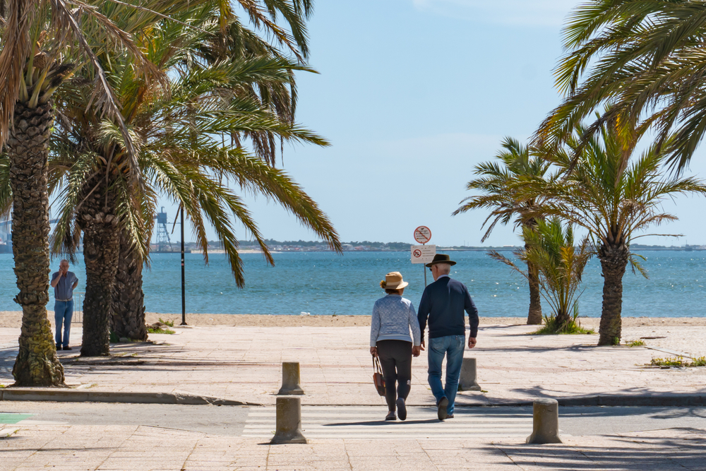 senior couple walking on the coastal side
