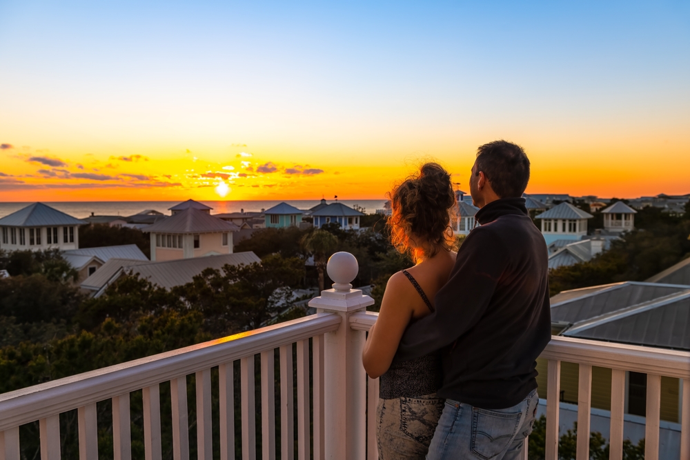 couple living in coastal watching sunset