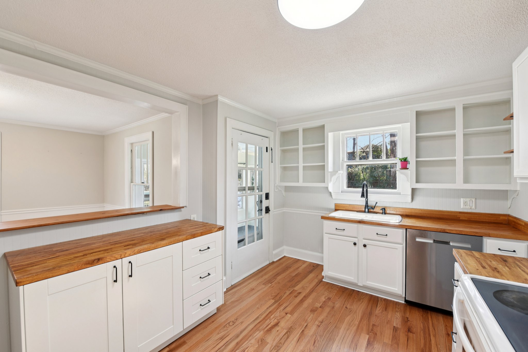concord-nc-bungalow-kitchen-butcher-block-counters.jpg Updated kitchen with butcher block counters and modern fixtures in renovated bungalow near downtown Concord NC.