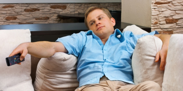 Bored sports fan watching tv