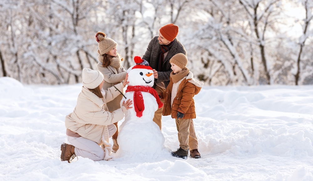 Family creating a snowman