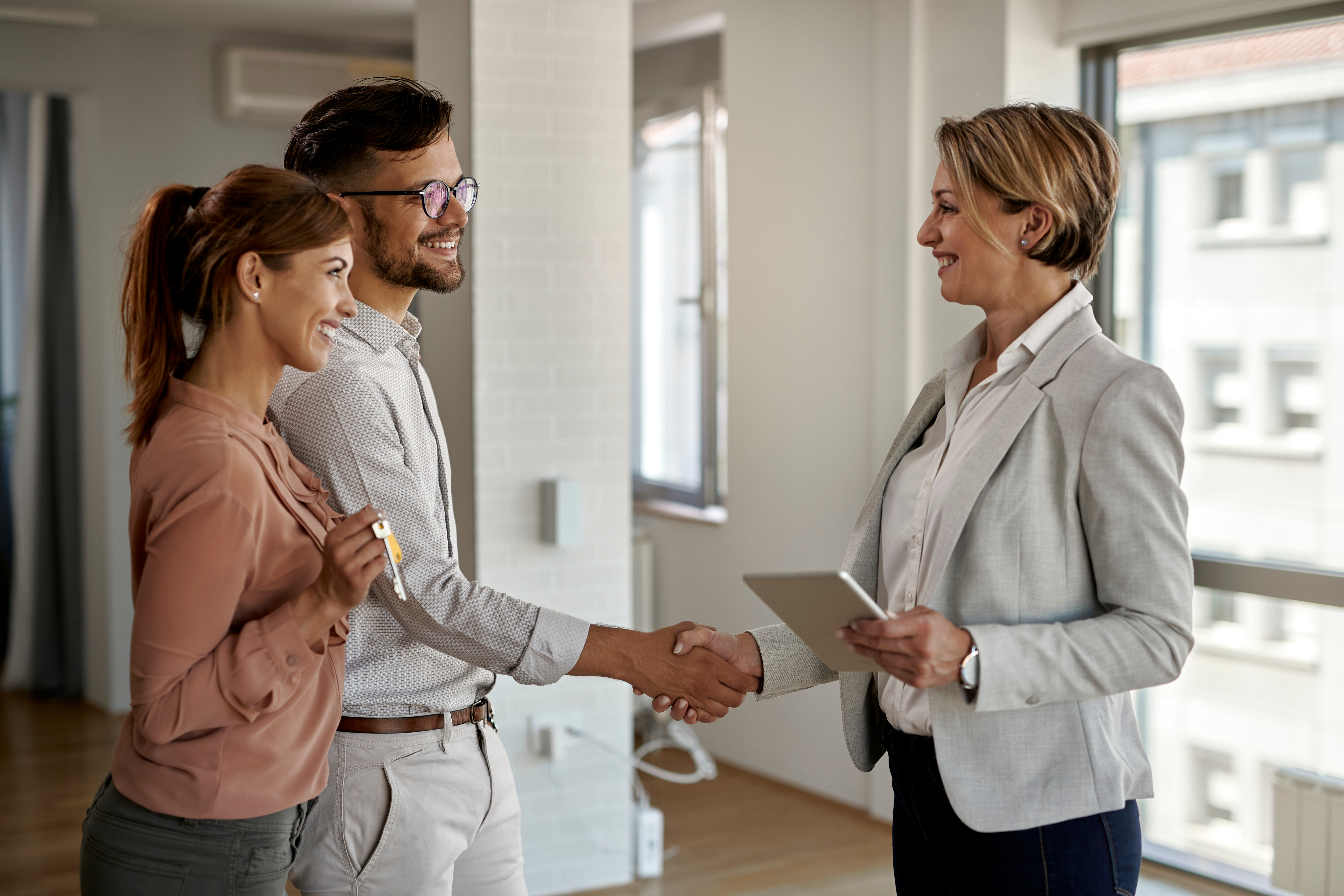 real estate agent handshaking with buyer