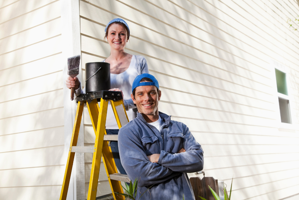 a couple painting their house