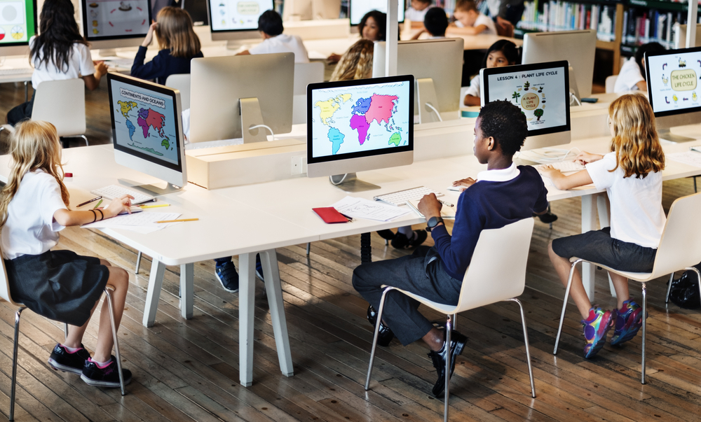 Children Using Computer Looking at a map