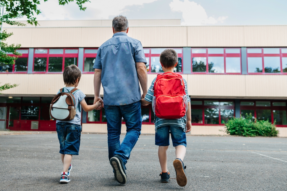 A father bringing his son to school