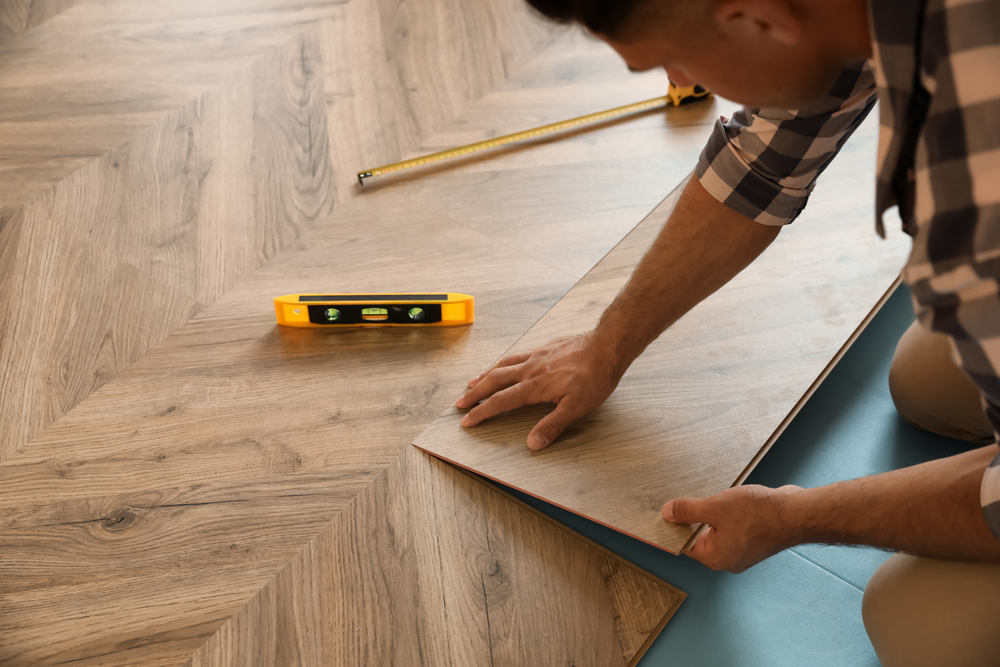 man installing new flooring