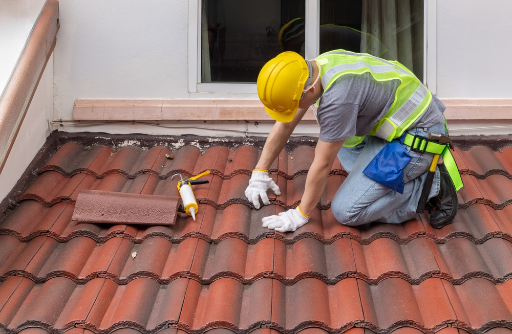 man repairing roof