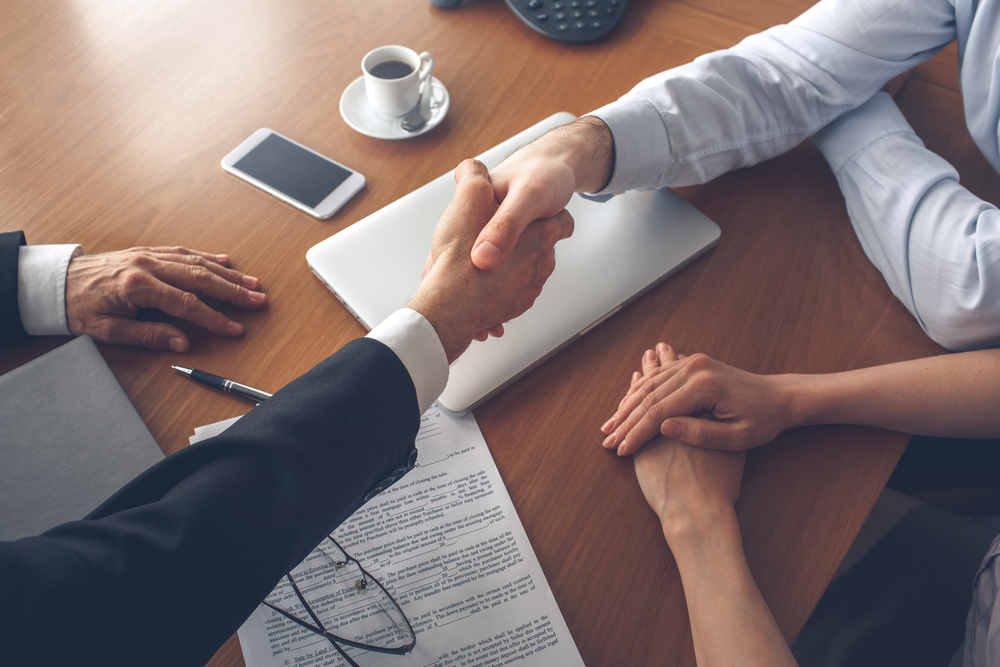 realtor and home buyer shaking hands