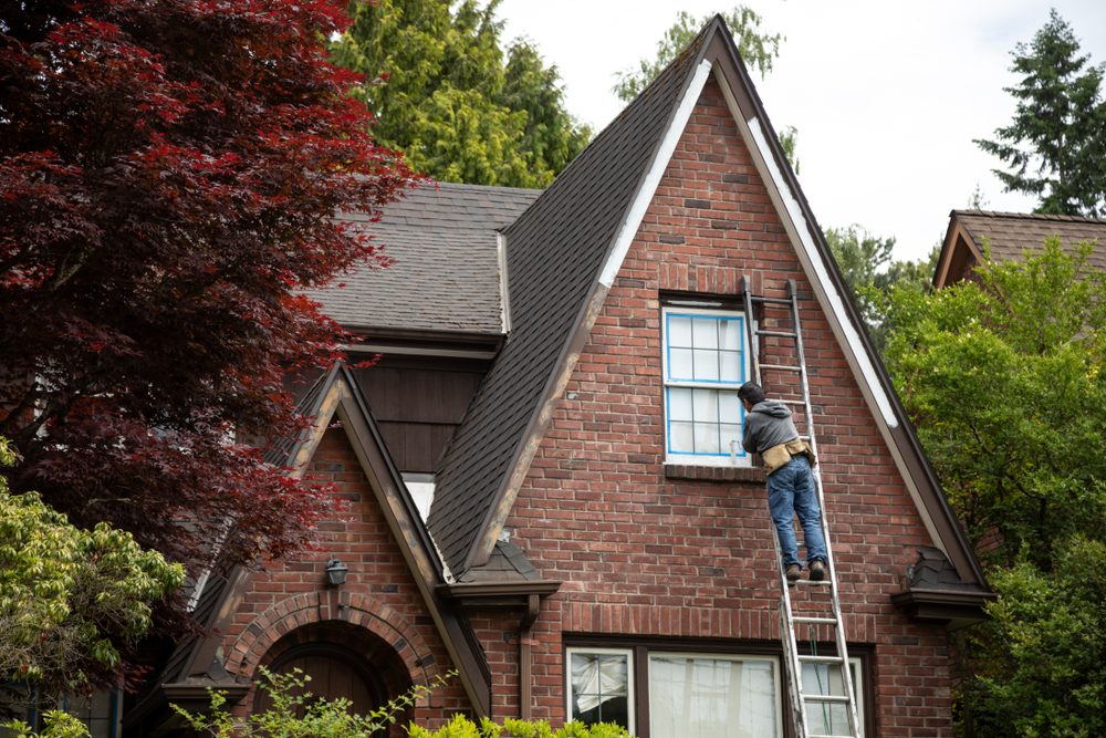 man doing exterior home maintenance for historical-house