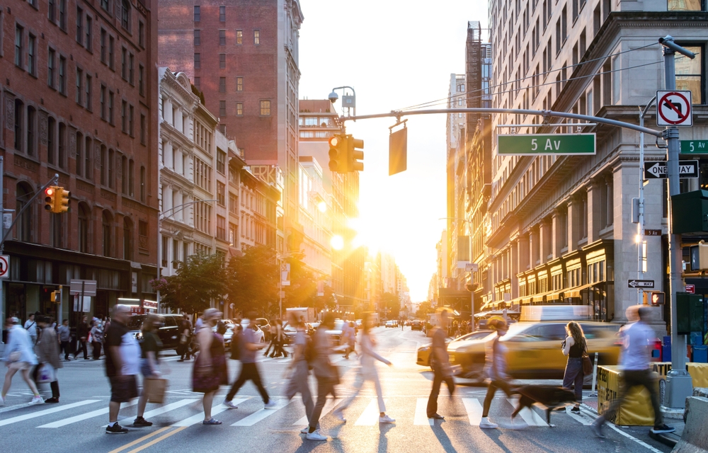 people walking in pedestrian along busy streets