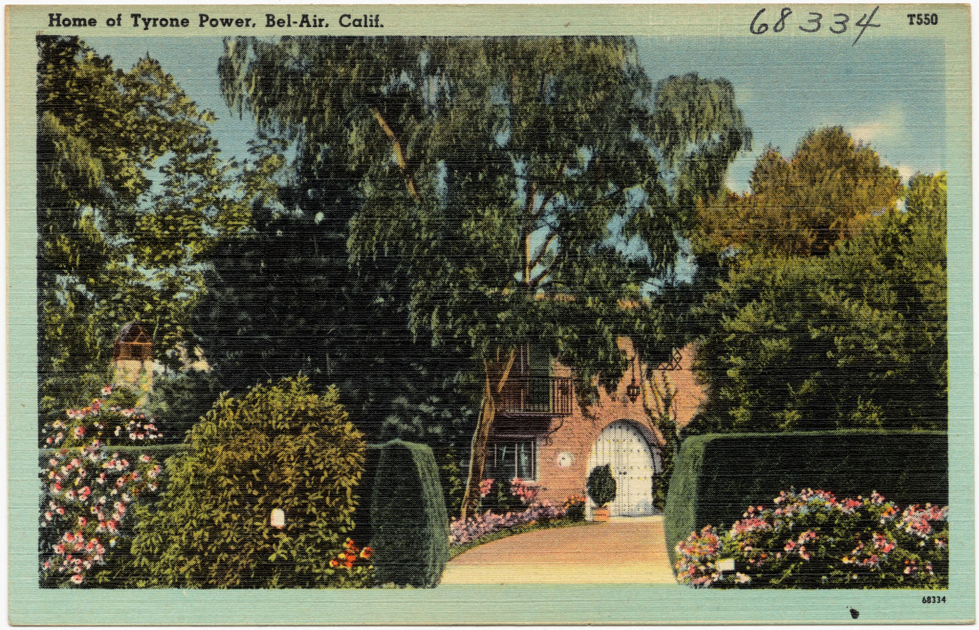 Vintage postcard labeled Home of Tyrone Power, Bel-Air, California, showing a secluded estate entrance with trees, hedges, flowers and a driveway.