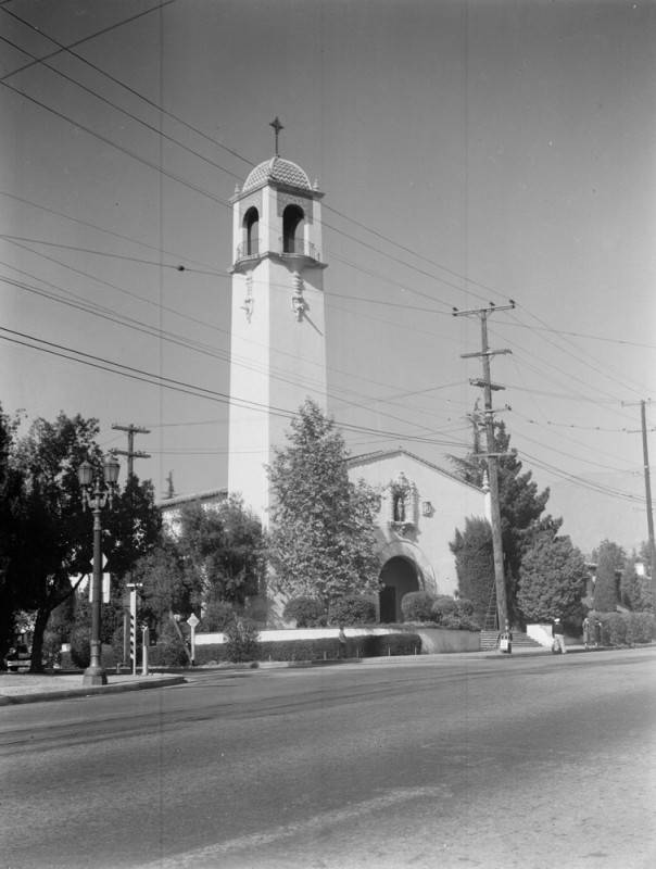 Historic black and white photograph of St. Elizabeth Church in Altadena with its tower, power lines and street in front.