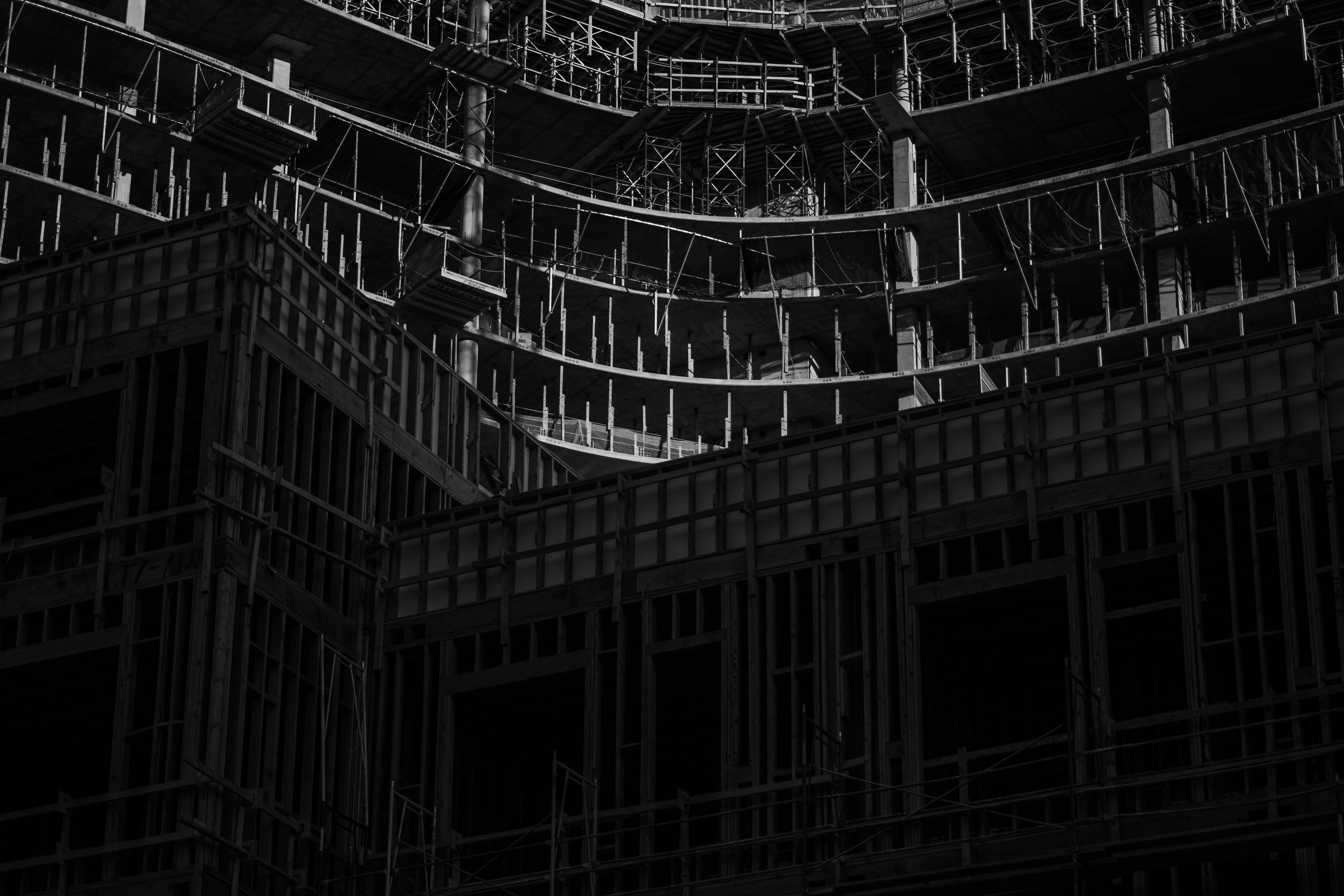 Black and white view of a large Koreatown construction project with exposed framing and scaffolding.
