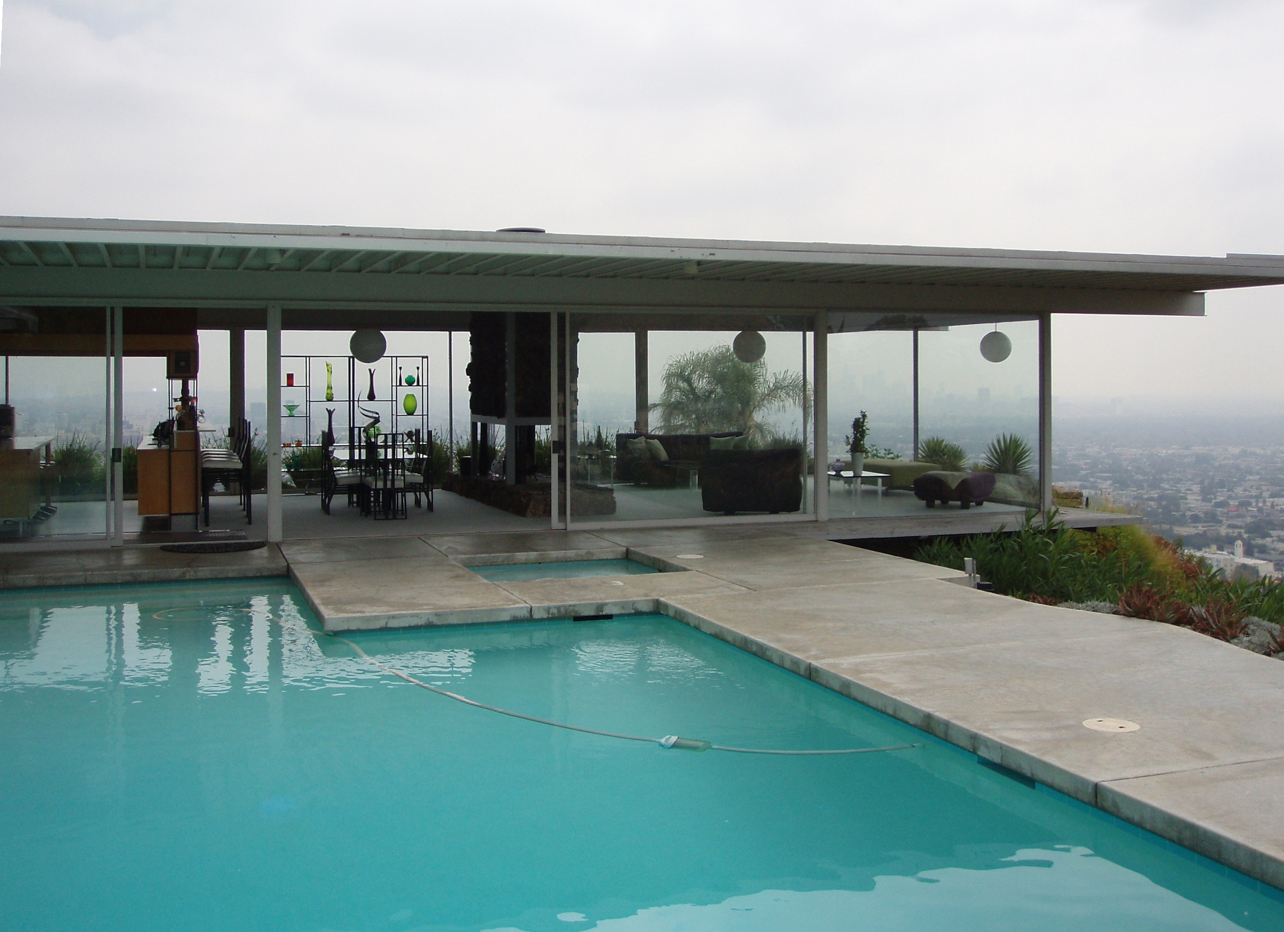 The Hollywood Hills became famous for homes that turned views, glass and hillside drama into architecture. Mid-century modern glass house with pool and panoramic view in the Hollywood Hills.