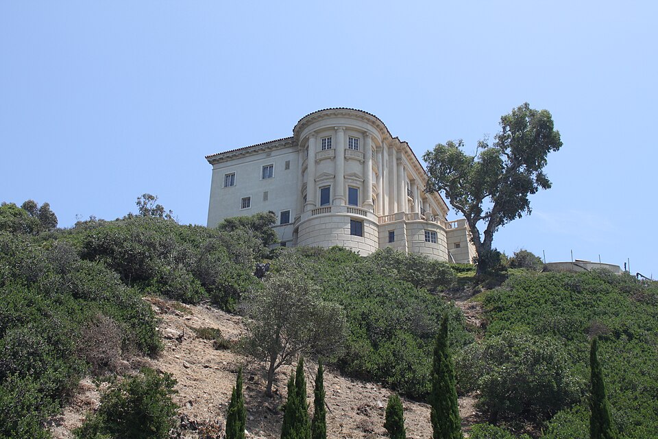 The Getty Villa, one of Pacific Palisades’ most recognizable cultural landmarks. Exterior view of the Getty Villa in Pacific Palisades, with the museum building rising above landscaped hillside greenery.