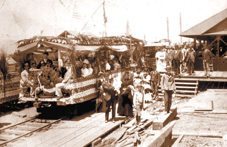 Historic photograph of passengers and workers gathered near the Mount Lowe Railway on opening day in Altadena.