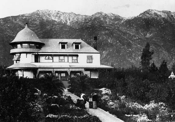 Historic black and white photograph of the McNally residence in Altadena with the San Gabriel Mountains behind it.