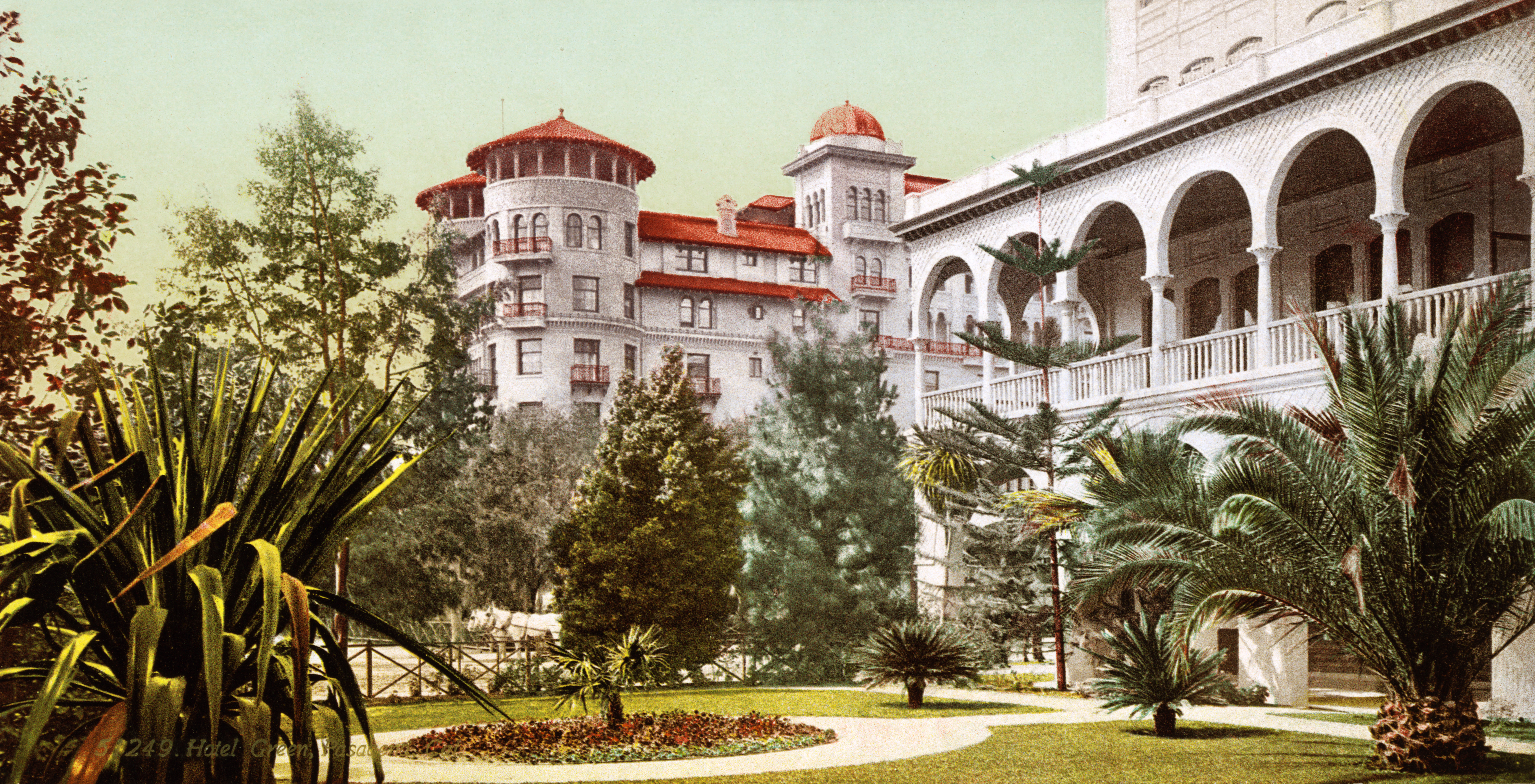 Vintage color image of Hotel Green in Pasadena with red roofs, arched porches, gardens, palm trees and ornate architecture.