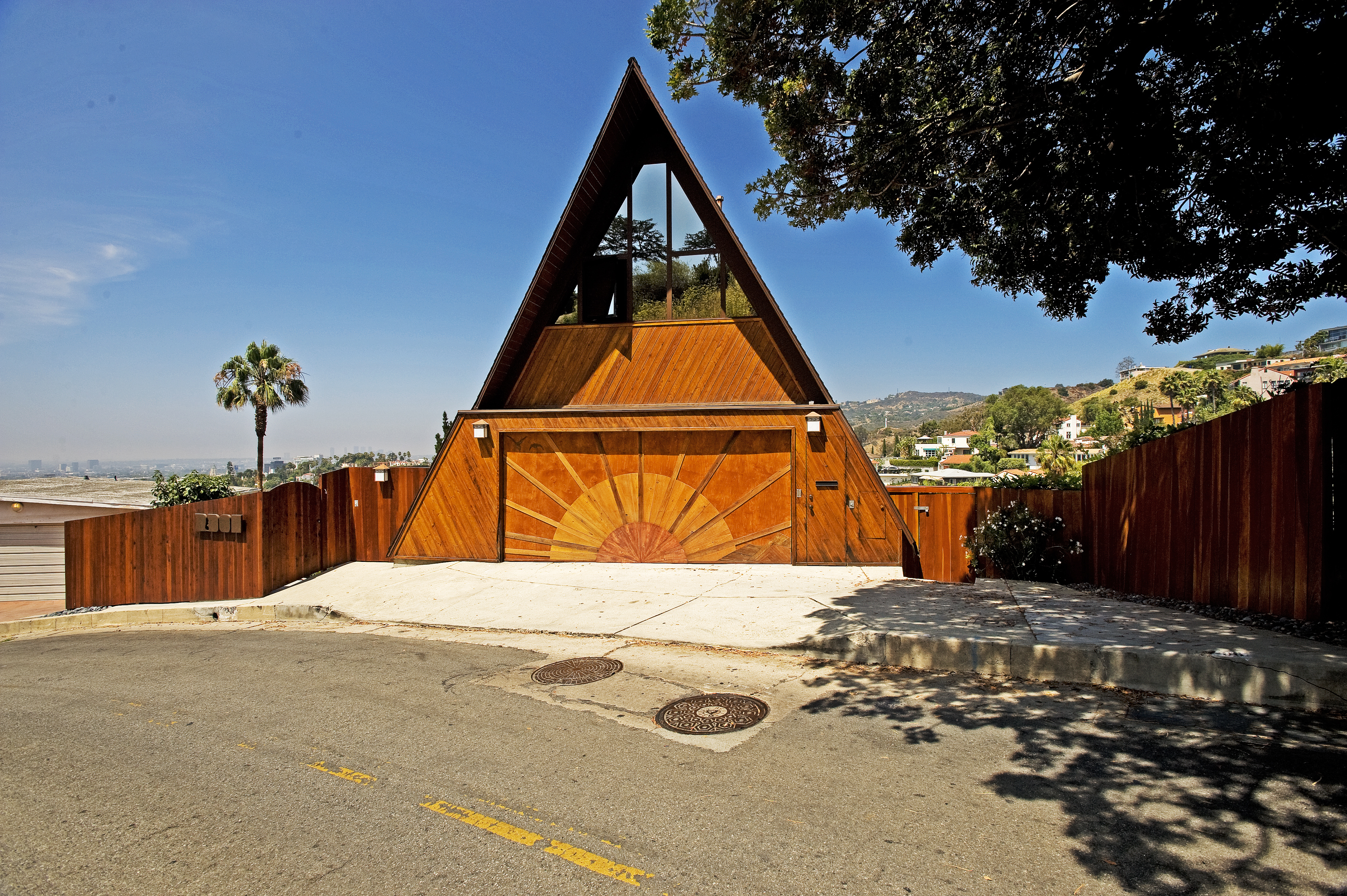 Hillside neighborhoods like Outpost Estates have room for architectural personality, from classic Hollywood homes to unusual modern retreats. A-frame style wood home in the Hollywood Hills near Outpost Estates.