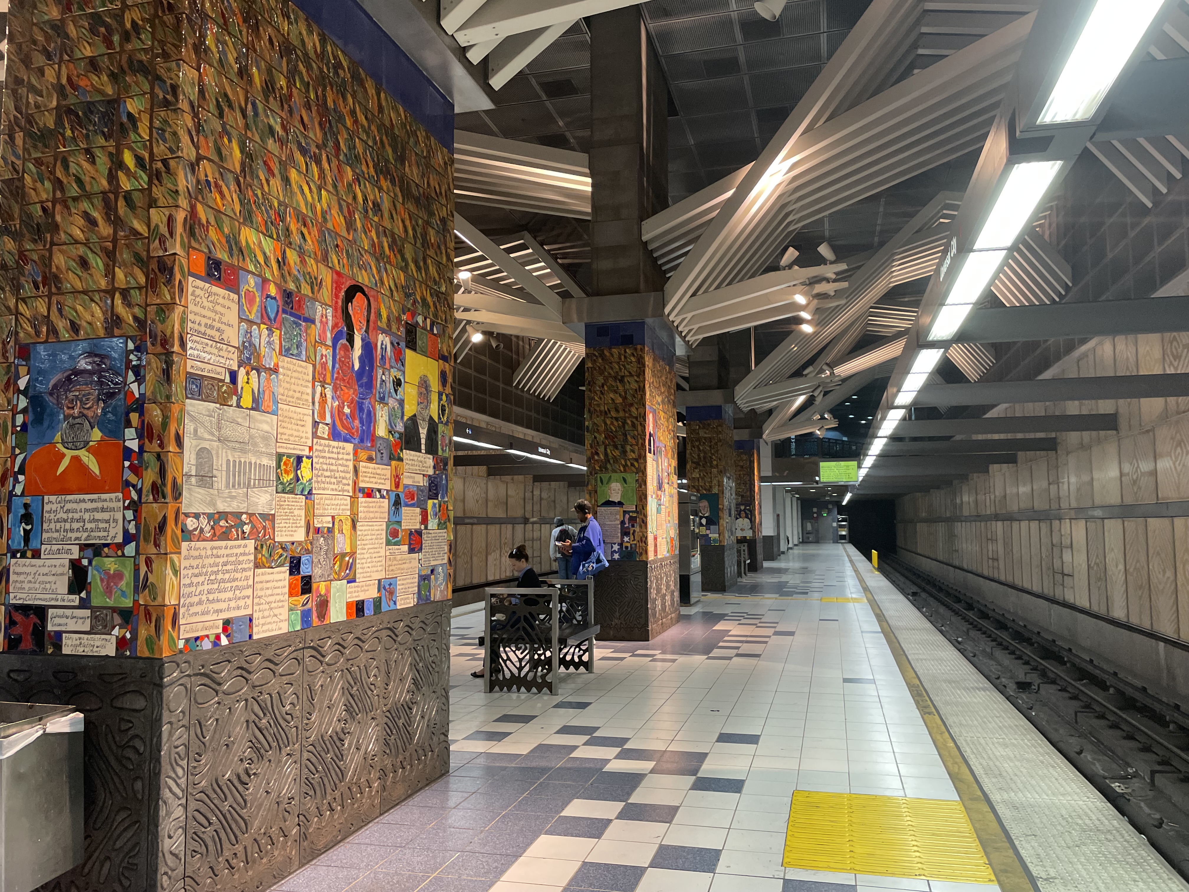 Transit access near Universal City and Studio City adds another layer to the neighborhood’s long-term appeal. Universal City Studio City Metro station platform with train and colorful tile artwork.