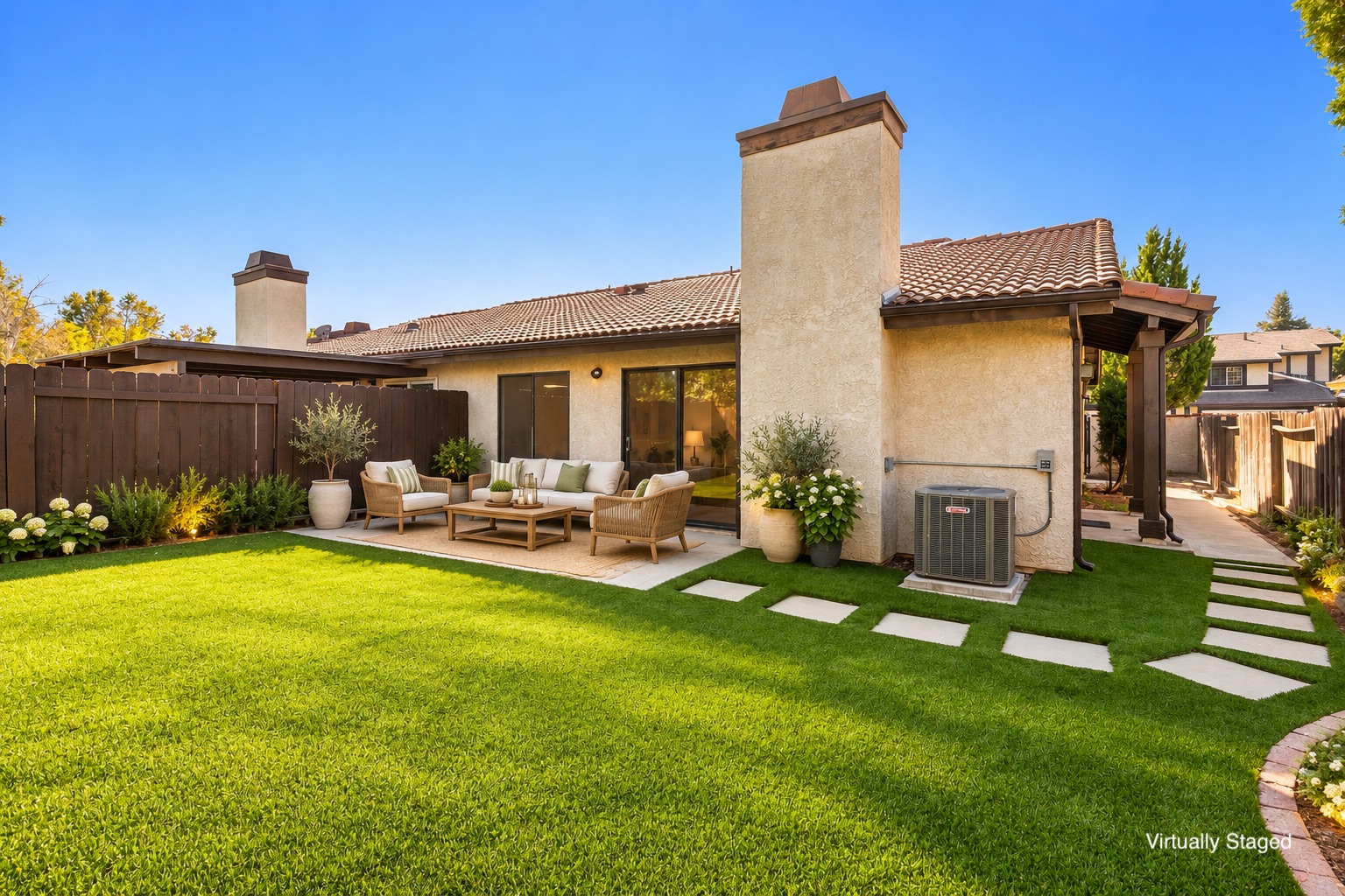 Private gated backyard at 26120 Galvez Ct, Santa Clarita, CA 91355, featuring artificial turf and stamped concrete. Single story home in the Sunrise community of North Valencia Valley listed at $635,000 by The Kathy Watterson Team at RE/MAX of Santa Clarita.