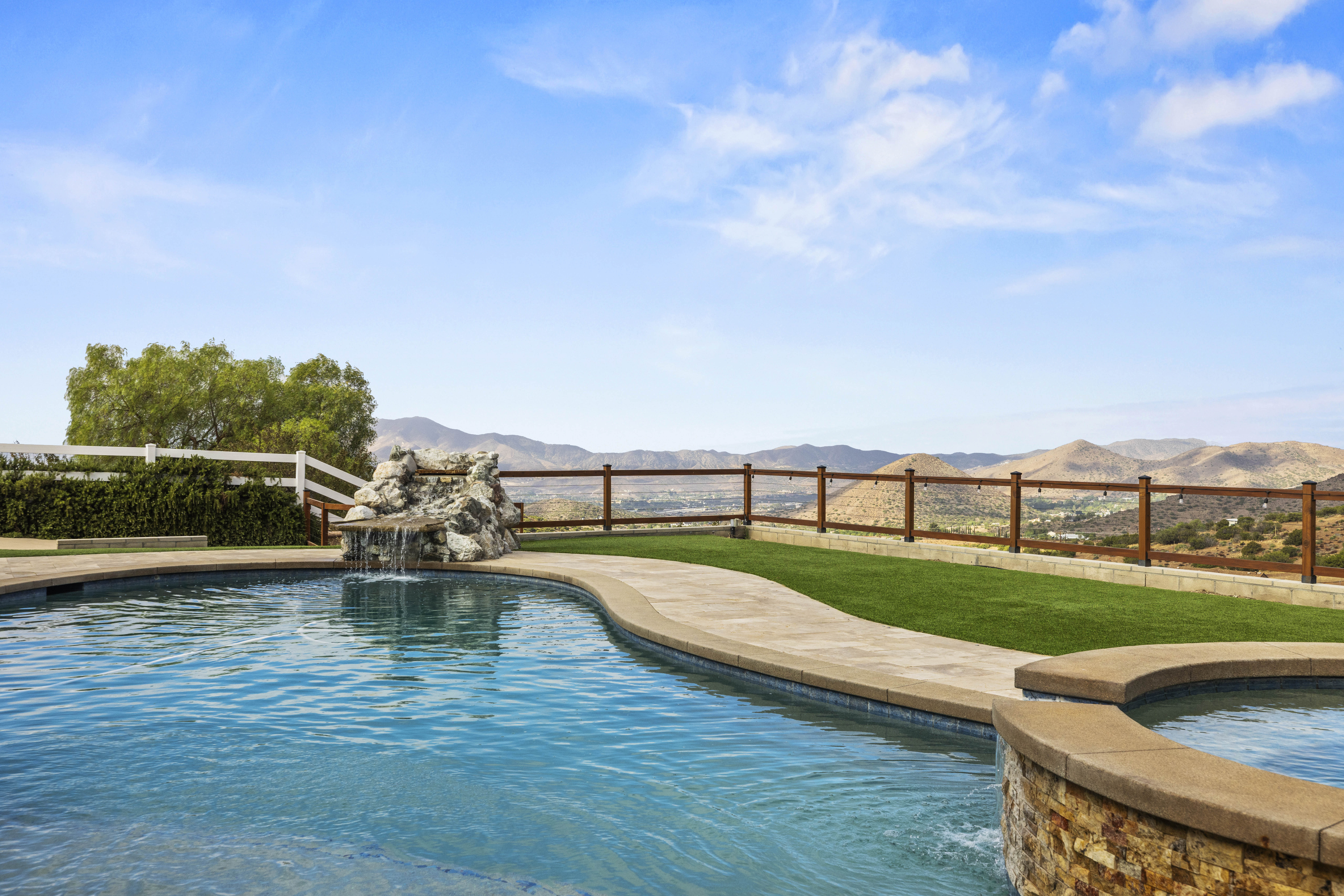 Pool and spa with water feature at 34665 Desert Rd, Acton CA, a 4-bedroom home on 1.5 fully fenced acres. Listed at $1,075,000 by The Kathy Watterson Team at RE/MAX of Santa Clarita.