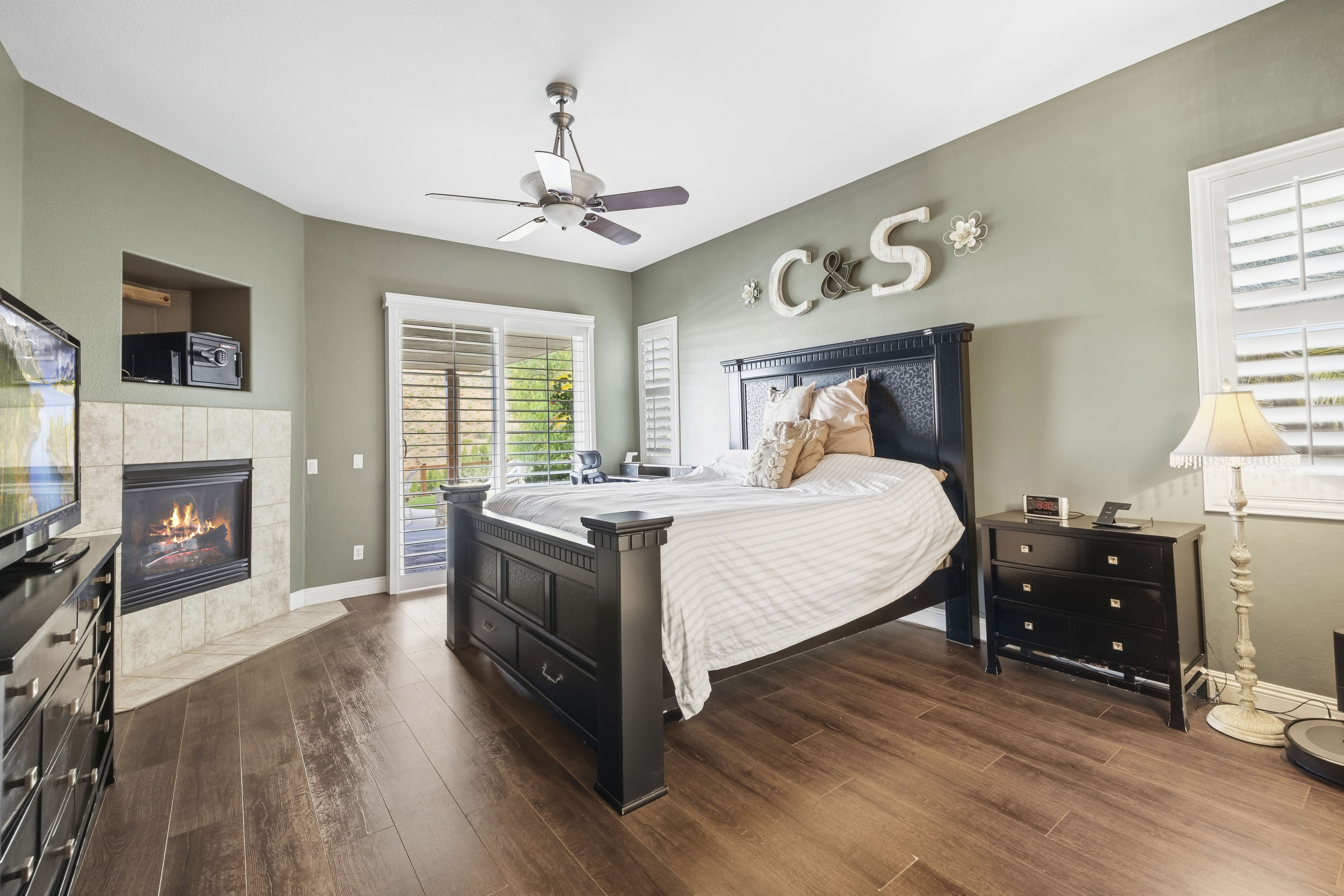 Primary suite with fireplace and patio access at 34665 Desert Rd, Acton CA. 4-bedroom, 3-bathroom home on 1.5 acres listed at $1,075,000 by The Kathy Watterson Team at RE/MAX of Santa Clarita.