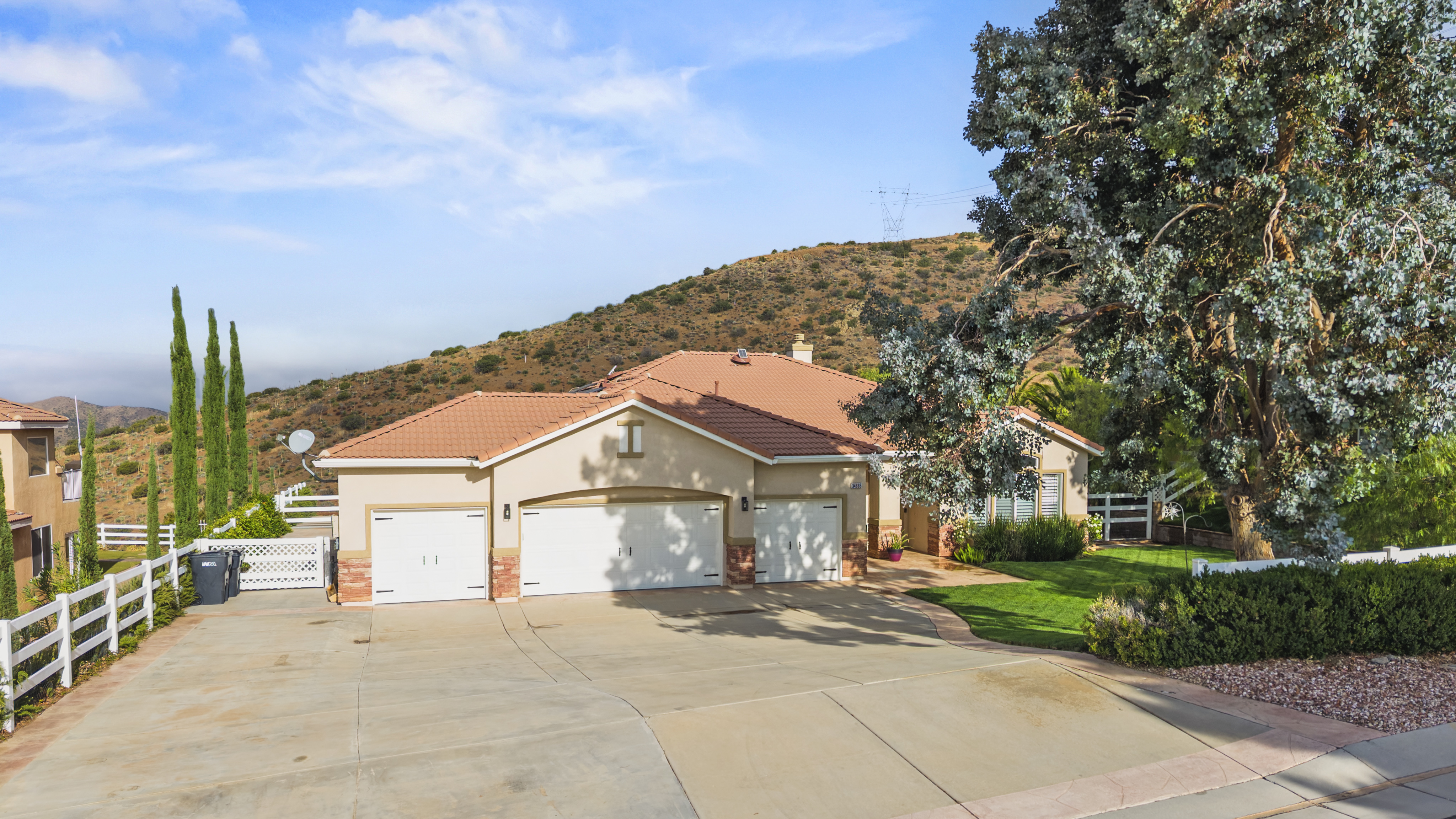 Front exterior of 34665 Desert Rd, Acton CA, a 4-bedroom, 3-bathroom home with 2,625 sq ft on 1.5 fully fenced acres. Listed at $1,075,000 by The Kathy Watterson Team at RE/MAX of Santa Clarita.