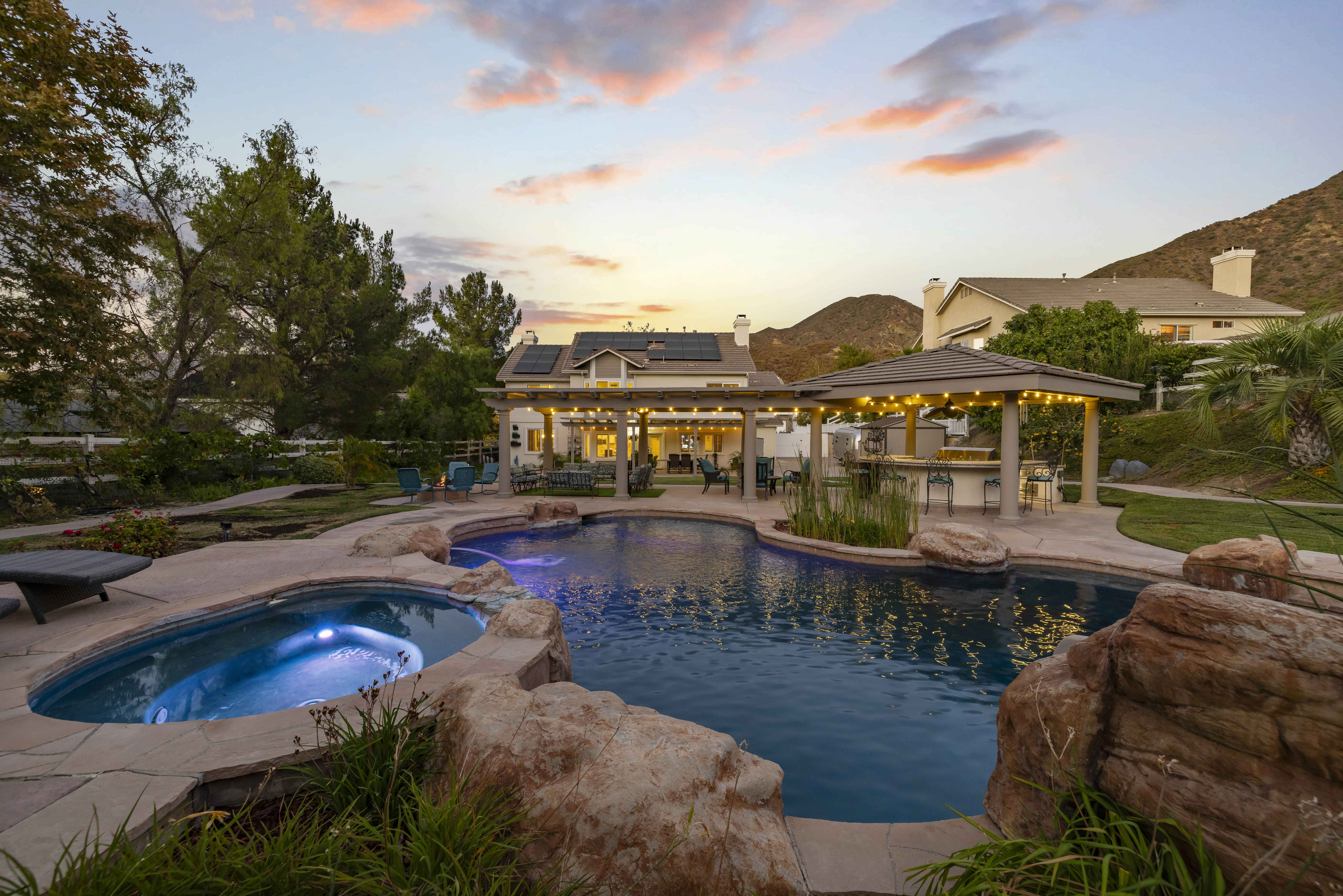 Resort-style backyard with pool and spa at 15260 Saddleback Rd, Santa Clarita, CA 91387, a 4-bedroom, 4-bathroom home on half an acre in the Ridgecrest tract of Sand Canyon. Sold by The Kathy Watterson Team at RE/MAX of Santa Clarita.