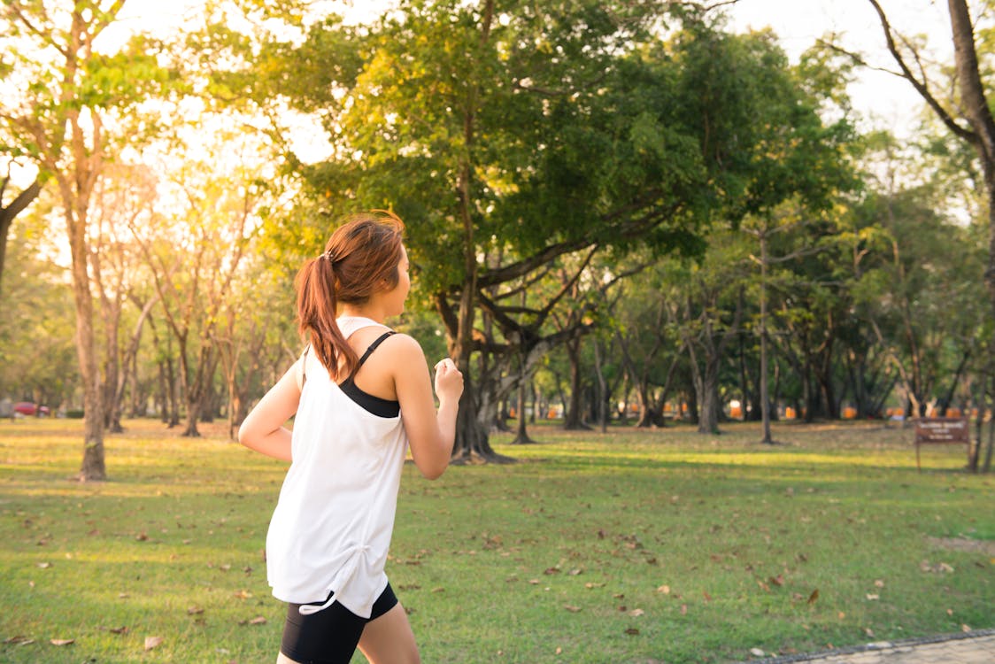 A girl running through a park