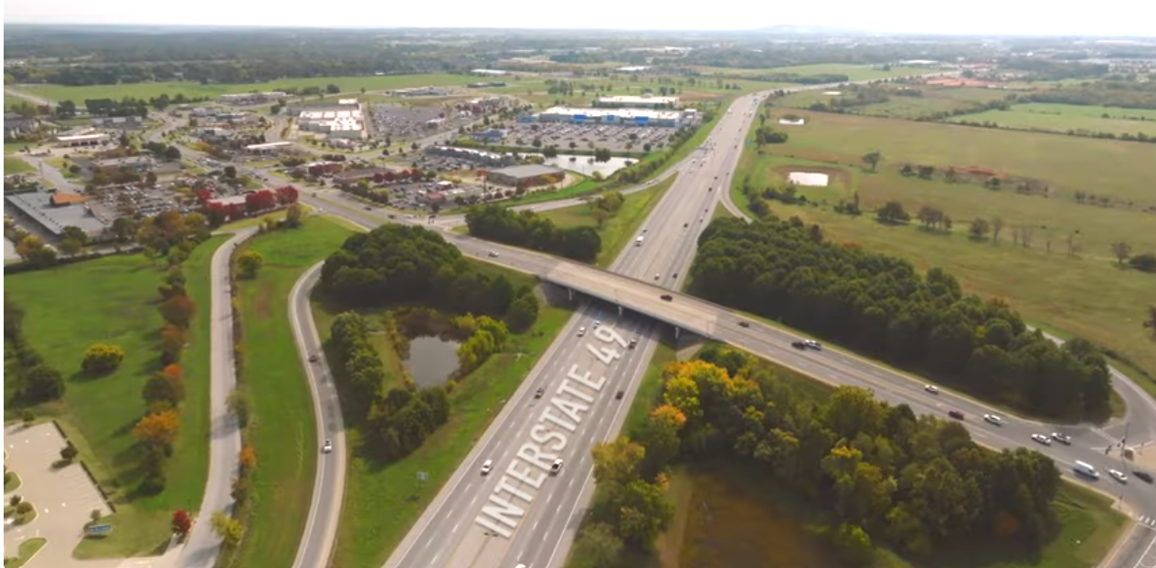 Aerial view of a Northwest Arkansas neighborhood with homes and green space