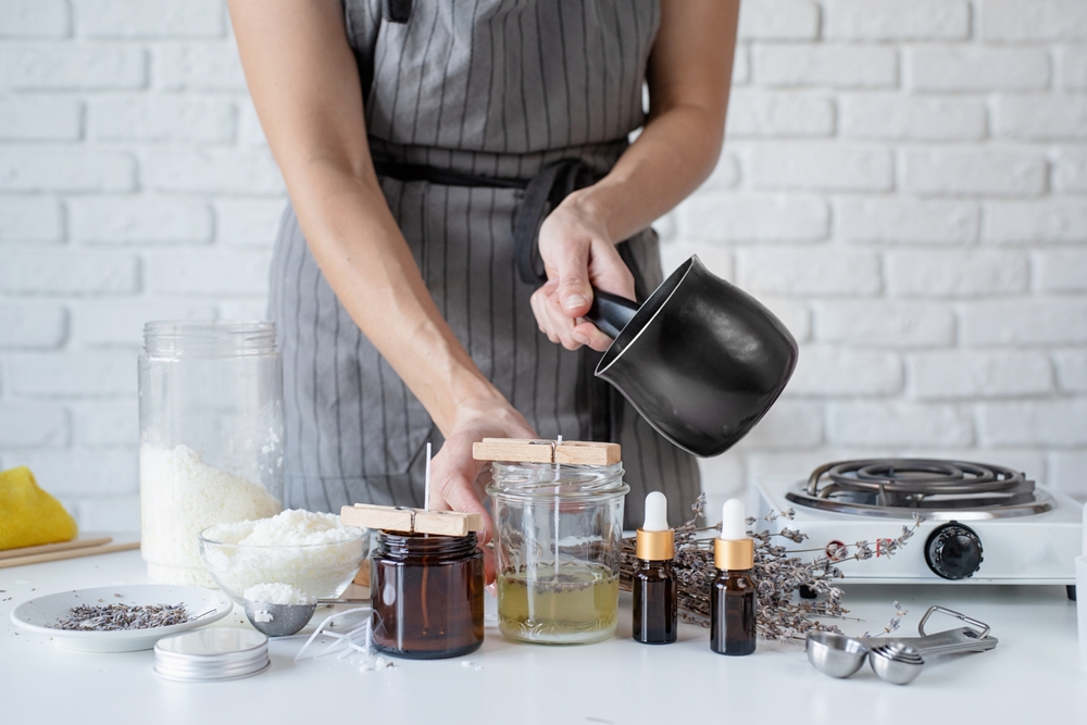 a woman making candles in the kitchen