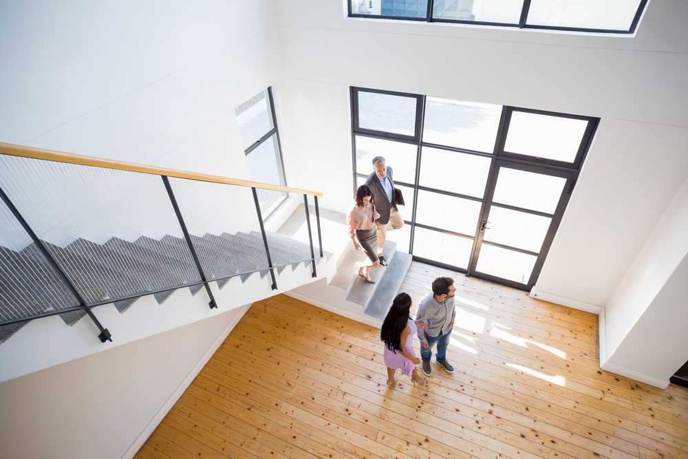 real estate agents doing a house tour for potential buyers