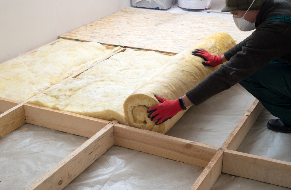 A worker installing insulation